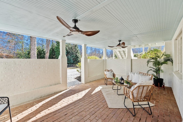 sunroom / solarium with a ceiling fan and a wealth of natural light