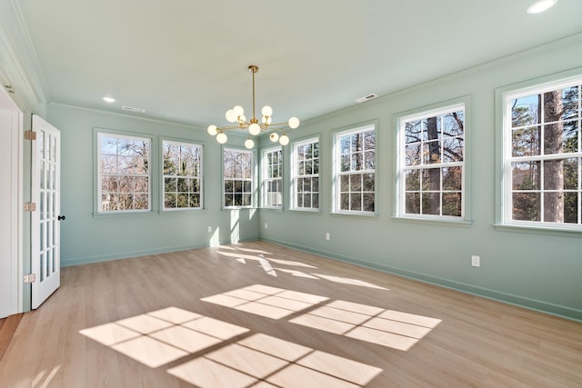 unfurnished sunroom featuring visible vents, plenty of natural light, and a chandelier