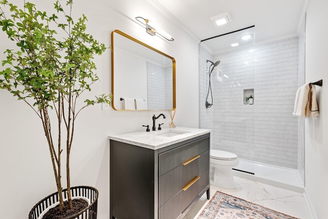 bathroom featuring marble finish floor, tiled shower, vanity, and toilet