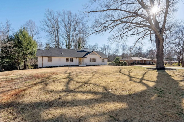 rear view of property with a yard and a chimney