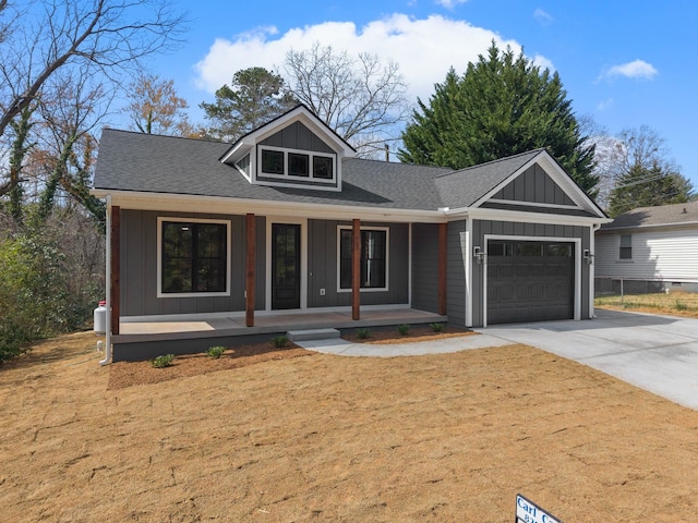 view of front facade featuring driveway, a porch, board and batten siding, a shingled roof, and a garage