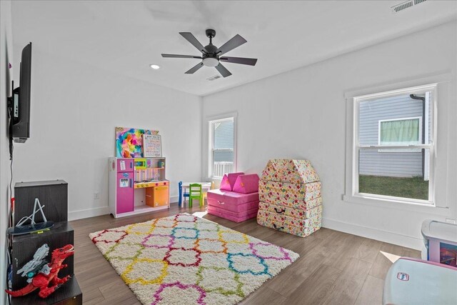 playroom with visible vents, baseboards, wood finished floors, and a ceiling fan