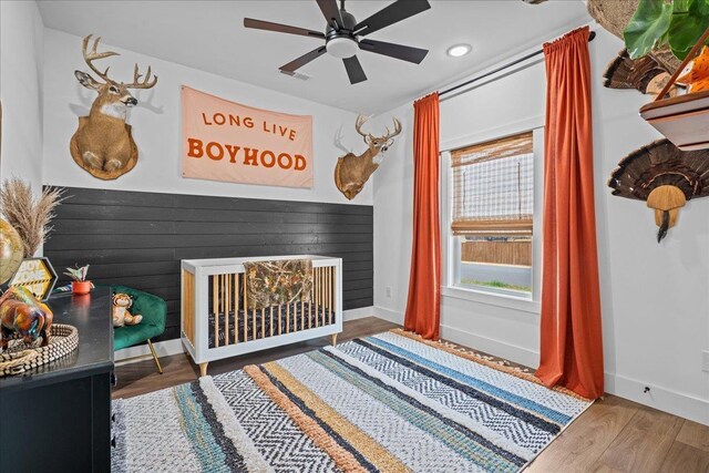 bedroom with ceiling fan, baseboards, and wood finished floors