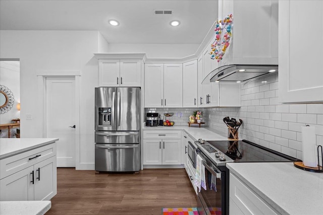 kitchen with visible vents, range with electric cooktop, stainless steel refrigerator with ice dispenser, light countertops, and dark wood-style flooring