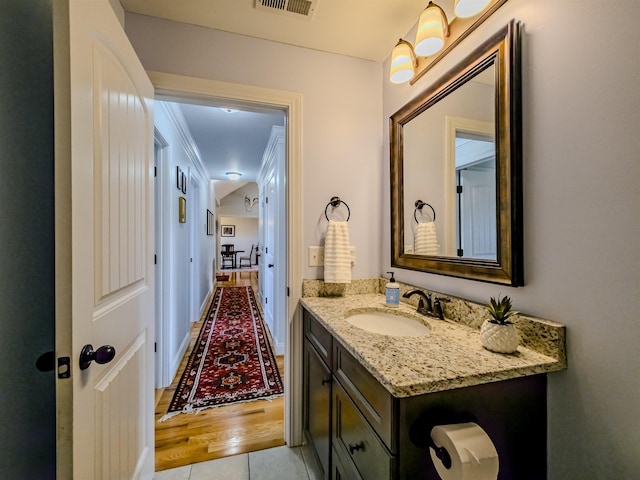 bathroom with visible vents, vanity, and tile patterned flooring