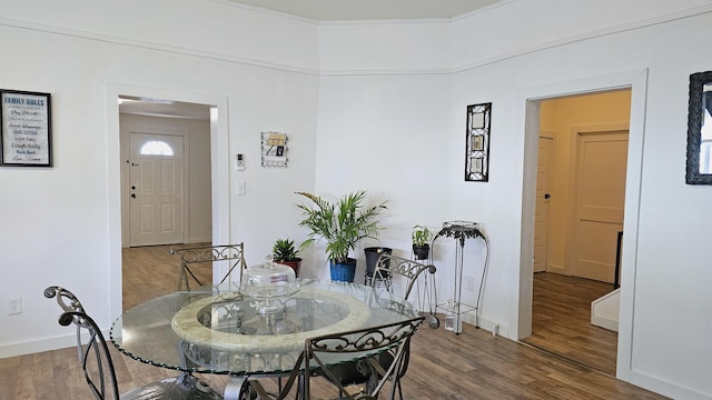 dining area featuring baseboards and wood finished floors