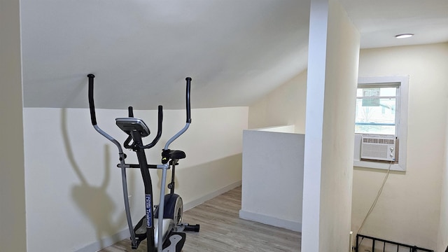 exercise room featuring baseboards and light wood-style flooring