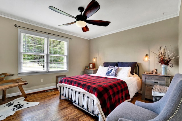 bedroom with wood finished floors and ornamental molding