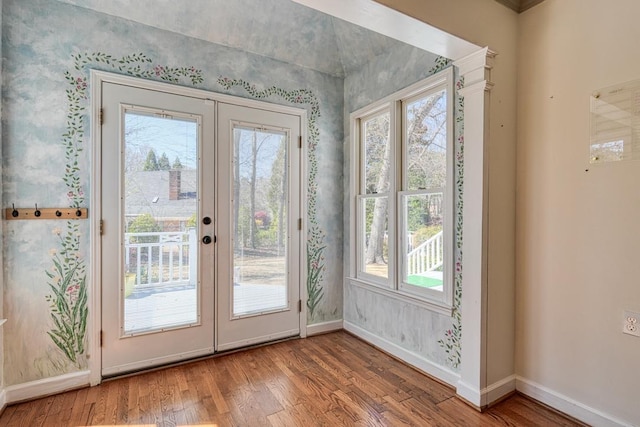entryway with a wealth of natural light, french doors, and wood finished floors