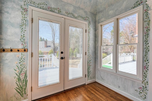 doorway to outside featuring wood finished floors, french doors, and baseboards