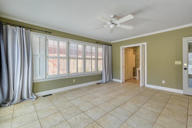 spare room with baseboards, visible vents, light tile patterned flooring, ceiling fan, and ornamental molding