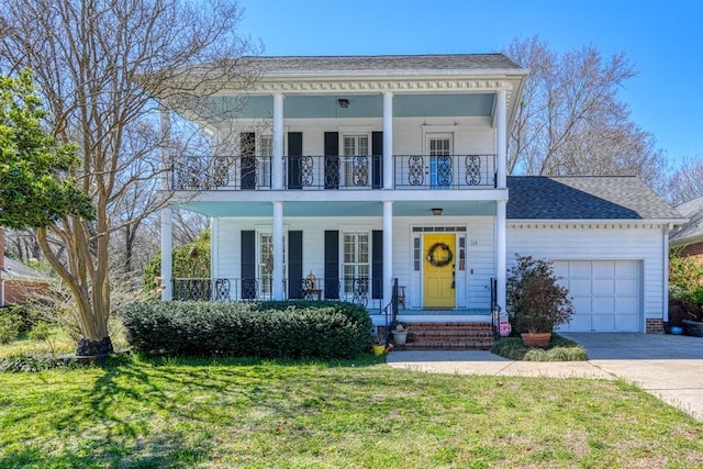 neoclassical home with a front yard, a balcony, a porch, an attached garage, and concrete driveway