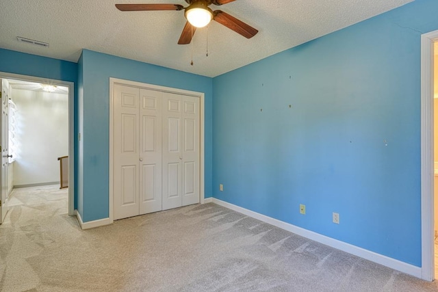 unfurnished bedroom with a closet, visible vents, baseboards, and carpet floors