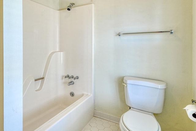full bath featuring tile patterned flooring, shower / tub combination, toilet, and baseboards
