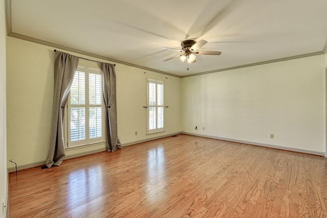 empty room with baseboards, light wood-style flooring, a ceiling fan, and ornamental molding