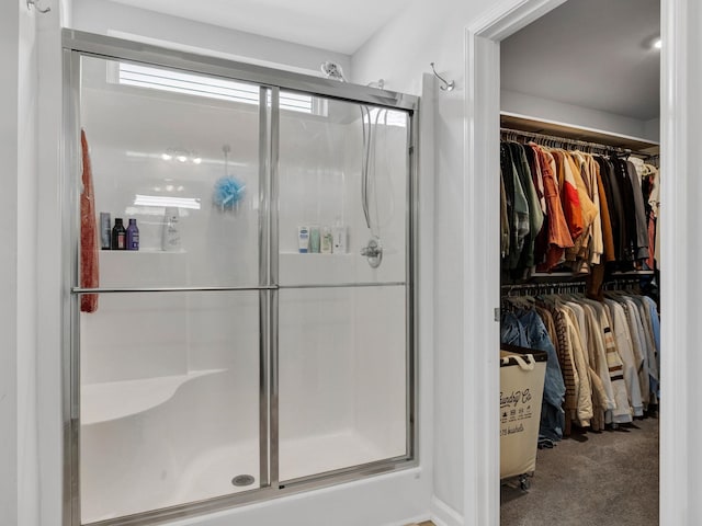 full bath with a spacious closet and a stall shower