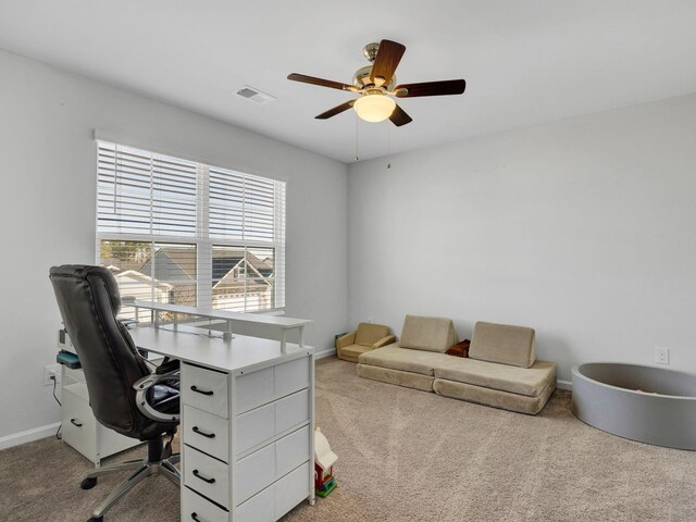 carpeted home office with visible vents, baseboards, and a ceiling fan