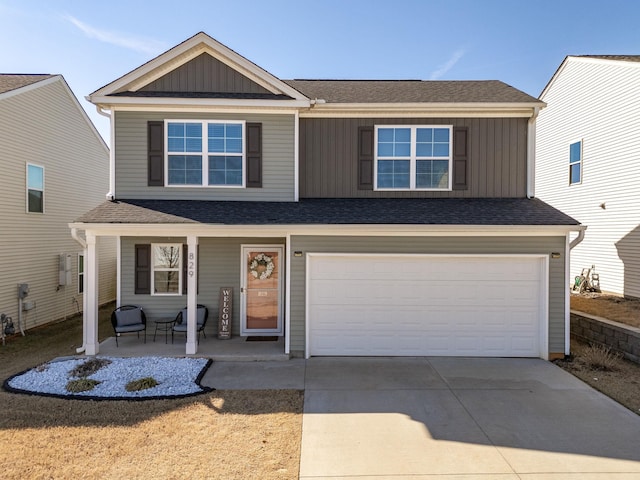 traditional home with board and batten siding, a porch, concrete driveway, and an attached garage