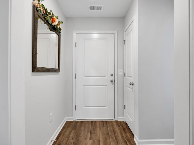 entryway with visible vents, baseboards, and dark wood-style flooring