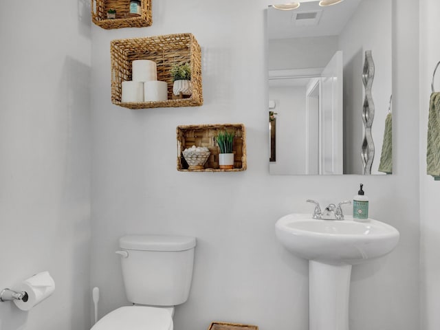 bathroom featuring visible vents and toilet