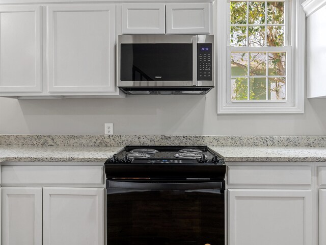 802 Linley, Anderson, SC 29625 - kitchen with white cabinets, electric range, light stone countertops, and stainless steel microwave