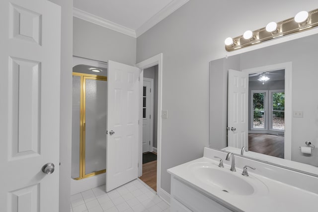 bathroom with tile patterned floors, vanity, a stall shower, and crown molding