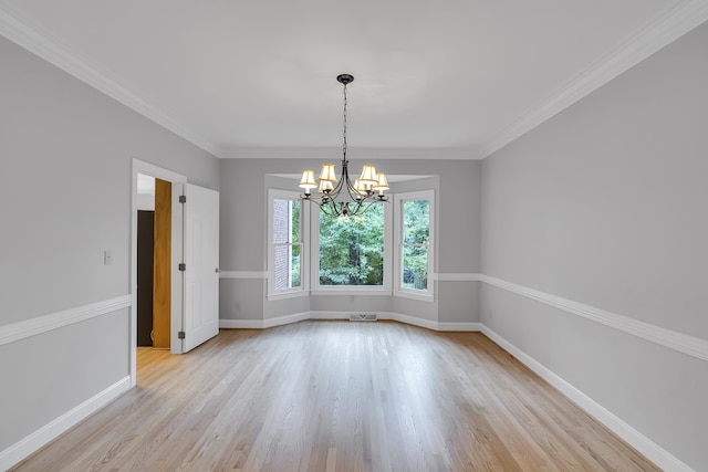 unfurnished room with baseboards, visible vents, a notable chandelier, and light wood finished floors