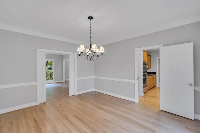 unfurnished room featuring baseboards, crown molding, an inviting chandelier, and light wood-type flooring