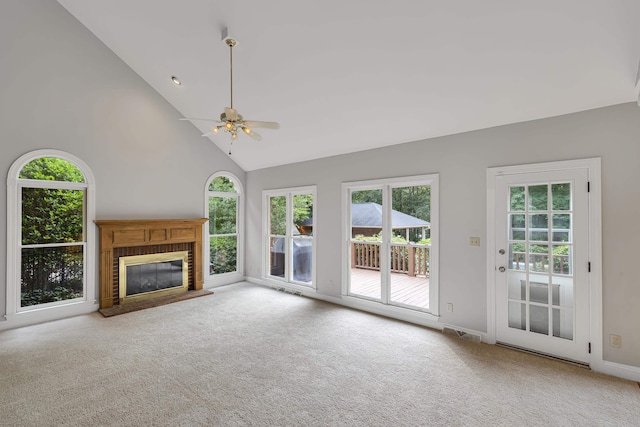 unfurnished living room featuring carpet flooring, high vaulted ceiling, visible vents, a brick fireplace, and ceiling fan