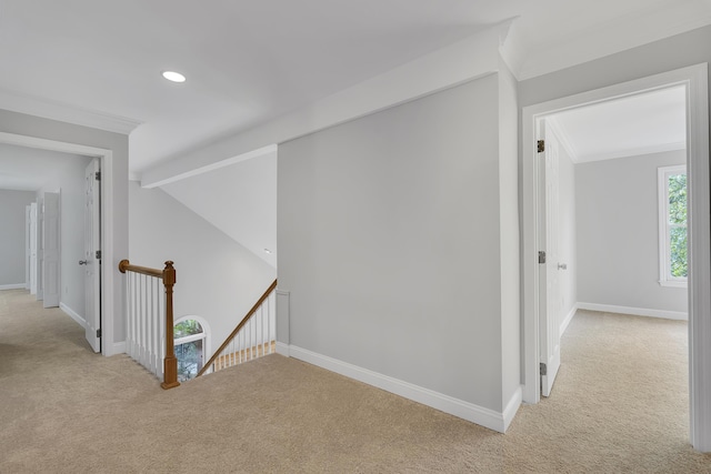 corridor with an upstairs landing, crown molding, baseboards, recessed lighting, and light carpet
