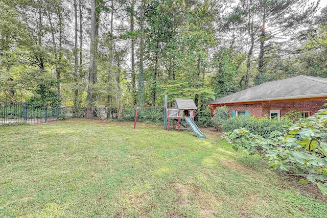 view of yard with a playground and fence
