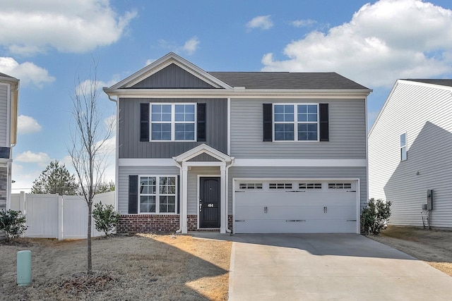 traditional home featuring an attached garage, fence, concrete driveway, and brick siding