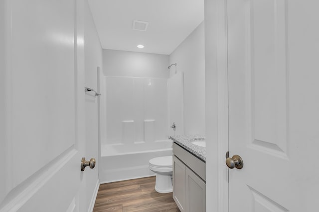 full bathroom featuring vanity, toilet, visible vents, shower / tub combination, and wood finished floors