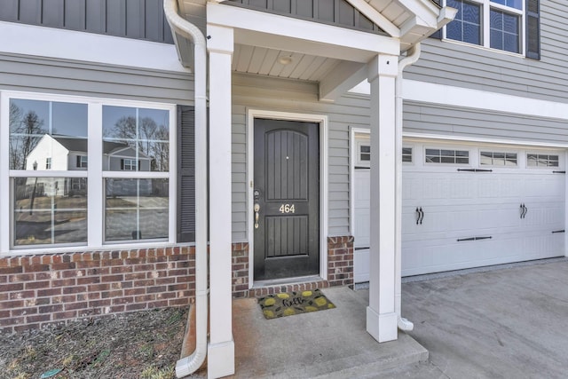 property entrance featuring a garage and board and batten siding