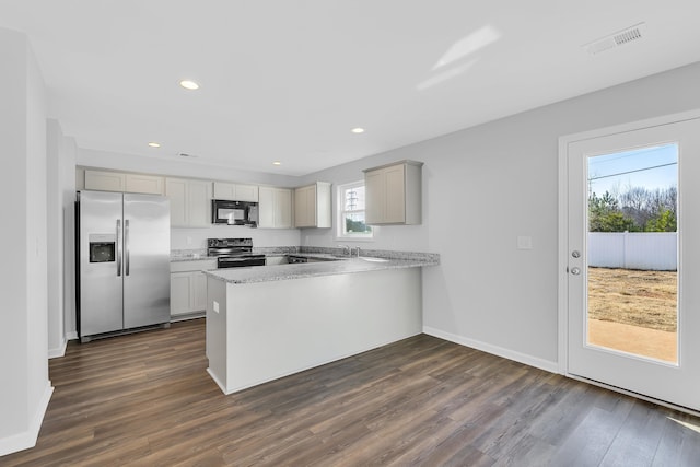 kitchen with visible vents, black appliances, a peninsula, and dark wood finished floors