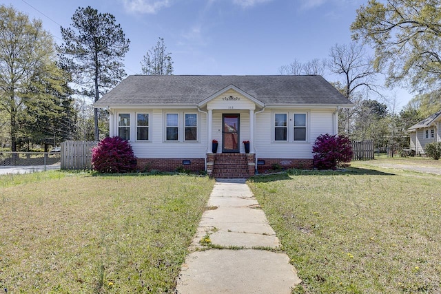 353 E Georgia, Woodruff, SC 29388 - bungalow-style home with roof with shingles, a front yard, crawl space, and fence