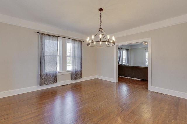 353 E Georgia, Woodruff, SC 29388 - unfurnished room with plenty of natural light, visible vents, an inviting chandelier, and dark wood finished floors