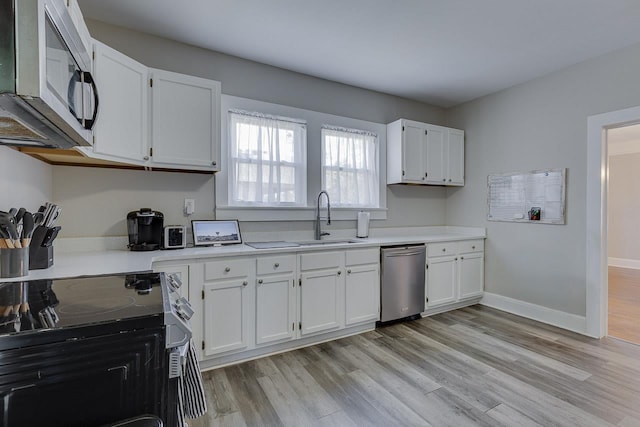 353 E Georgia, Woodruff, SC 29388 - kitchen with white cabinets, light countertops, a sink, and stainless steel appliances