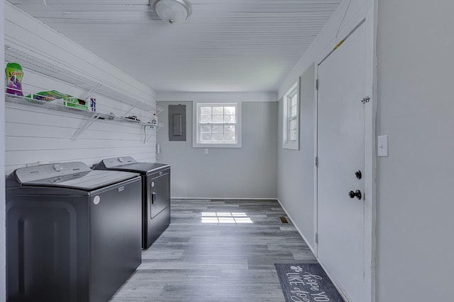 353 E Georgia, Woodruff, SC 29388 - clothes washing area featuring washing machine and dryer, laundry area, electric panel, and light wood-type flooring