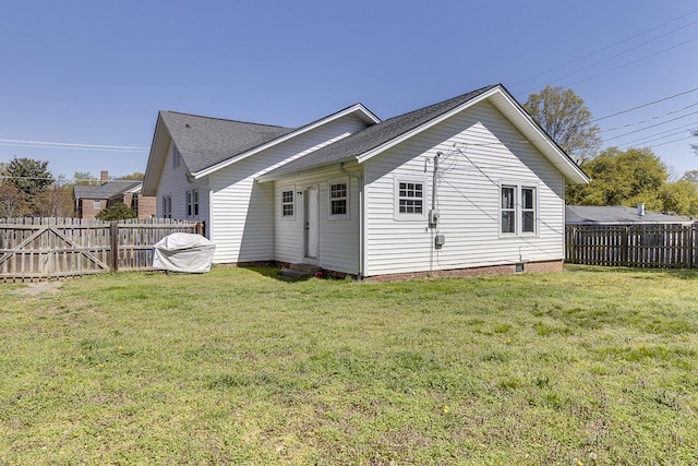 353 E Georgia, Woodruff, SC 29388 - back of house with a fenced backyard, roof with shingles, and a yard