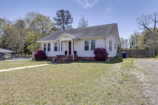353 E Georgia, Woodruff, SC 29388 - bungalow featuring a front lawn, crawl space, a shingled roof, and fence