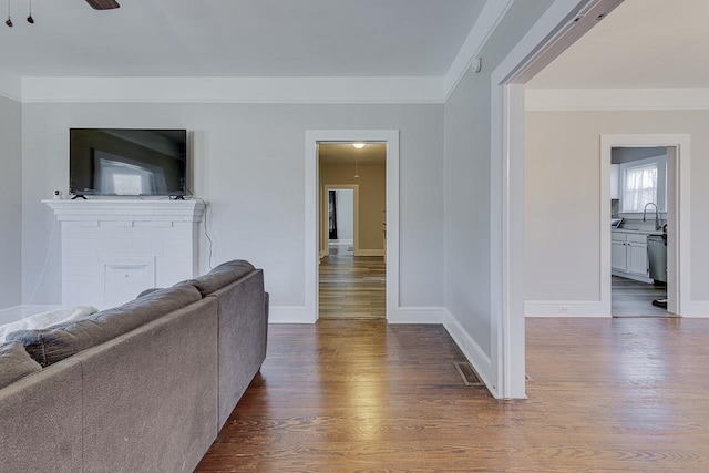 353 E Georgia, Woodruff, SC 29388 - unfurnished living room featuring a ceiling fan, a sink, baseboards, and dark wood finished floors