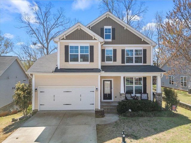 craftsman-style home with driveway, covered porch, and a front lawn
