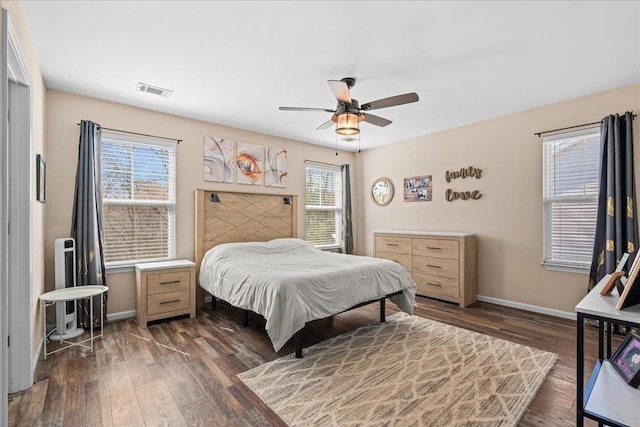 bedroom with baseboards, visible vents, ceiling fan, and dark wood-type flooring