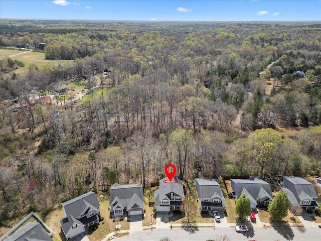 birds eye view of property featuring a residential view and a view of trees