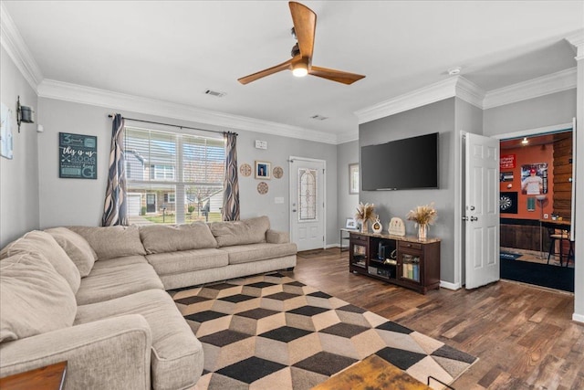 living room featuring baseboards, dark wood-style flooring, ornamental molding, and a ceiling fan