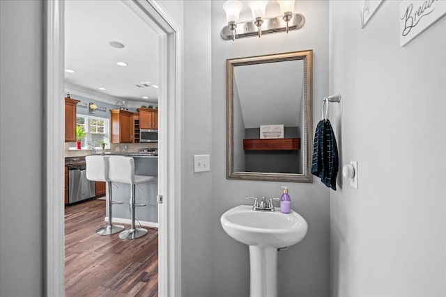 bathroom featuring recessed lighting, tasteful backsplash, and wood finished floors