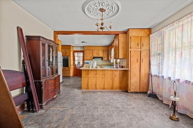 239 Phillips, Greenville, SC 29609 - kitchen featuring light countertops, a chandelier, a peninsula, brown cabinetry, and extractor fan
