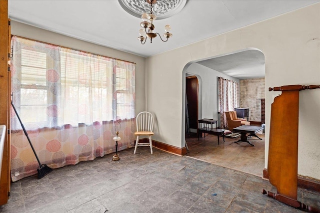 239 Phillips, Greenville, SC 29609 - sitting room featuring baseboards, a notable chandelier, and arched walkways