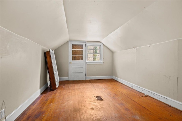 239 Phillips, Greenville, SC 29609 - additional living space featuring hardwood / wood-style floors, baseboards, visible vents, and vaulted ceiling